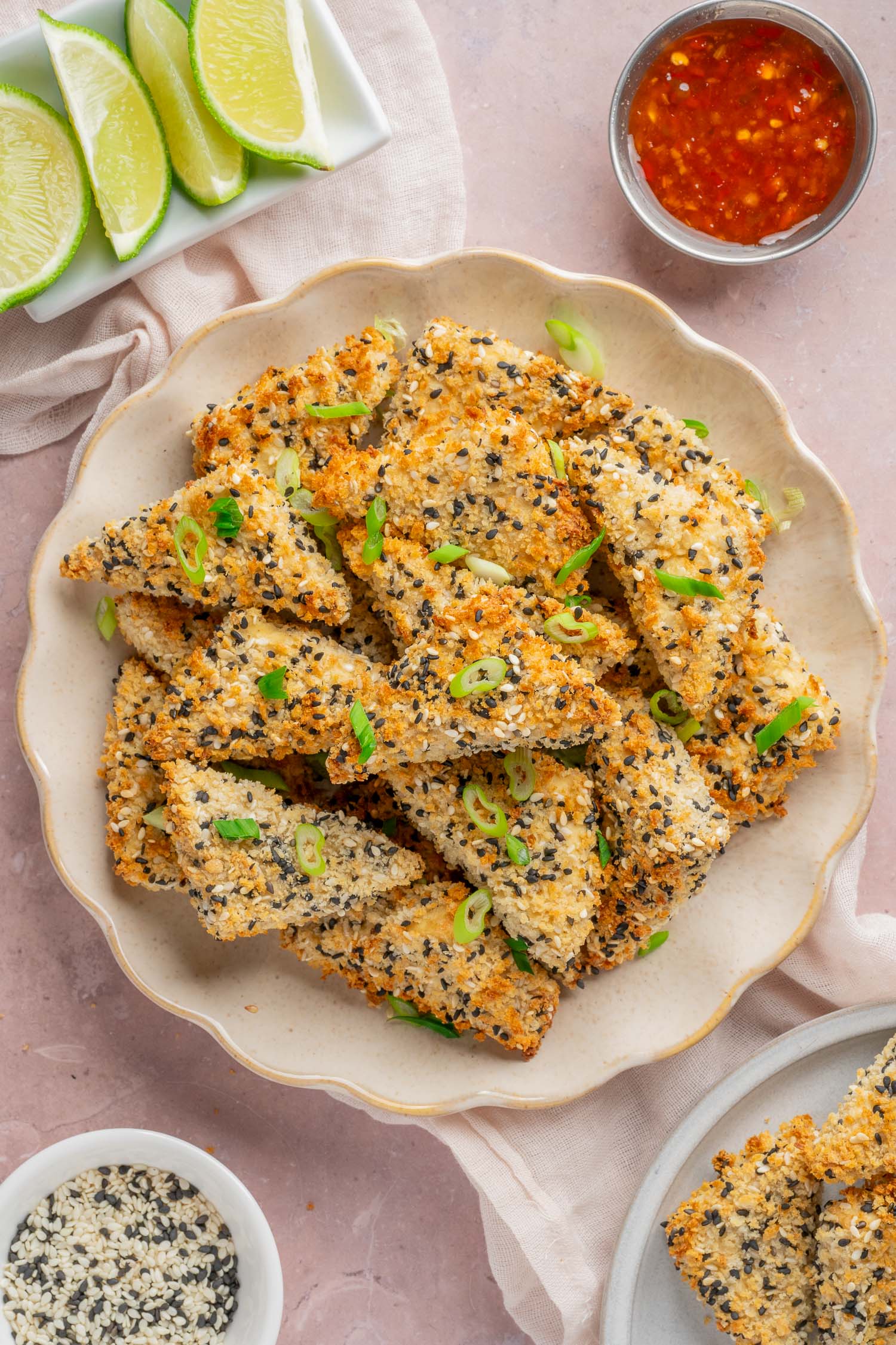 plate of sesame breaded tofu with fresh lime and dipping sauce
