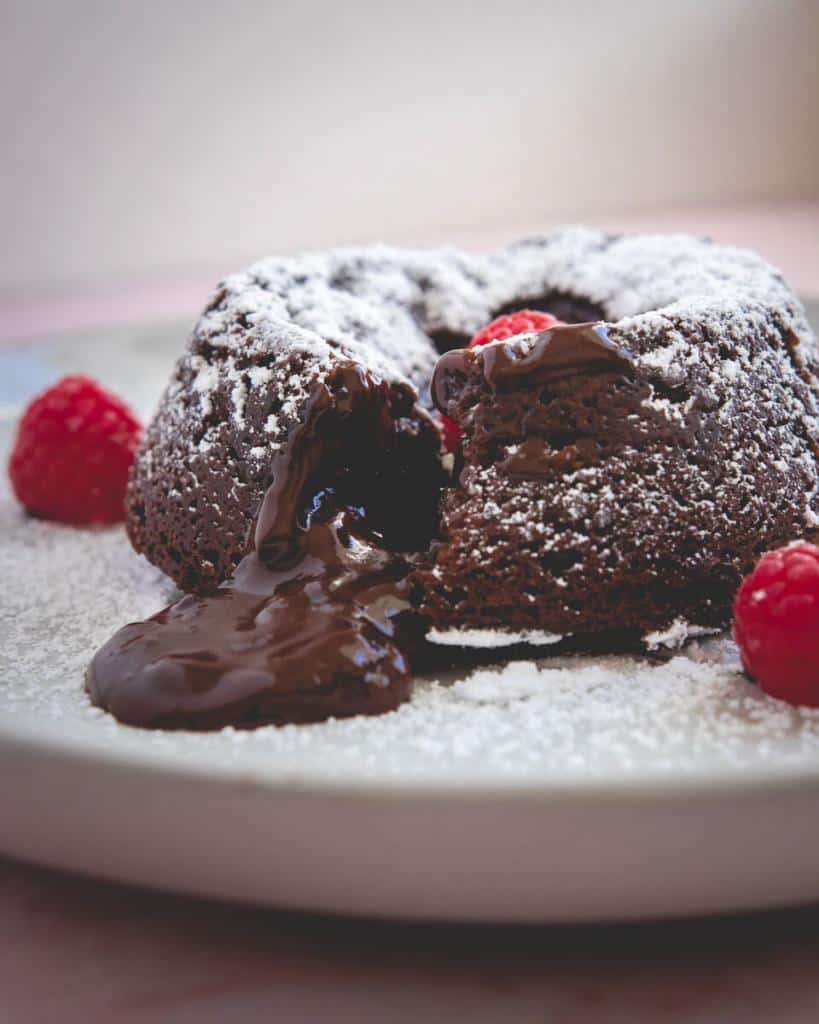 macro shot of chocolate lava cake, cut into, with molten chocolate center flowing out