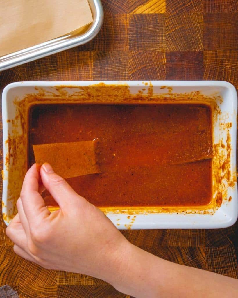 dipping rice paper strips in bacon marinade