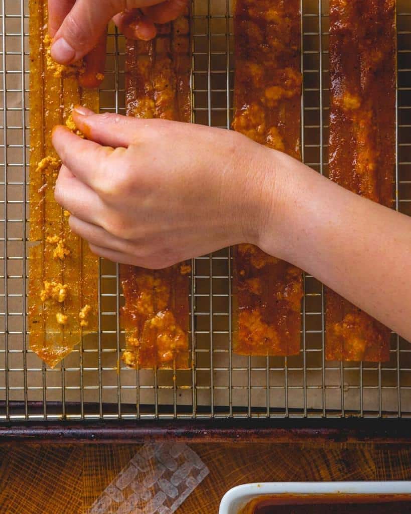 adding crumbled tofu to strips of rice paper