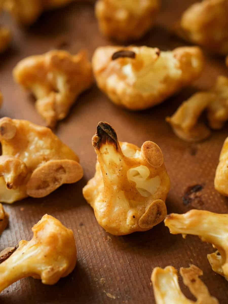 close up shot of battered cauliflower floret on baking tray