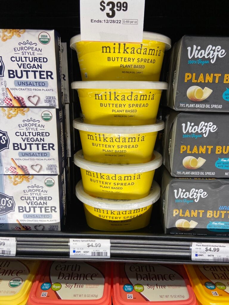 a stack of Milkadamia Buttery Spread containers in a grocery store refrigerator