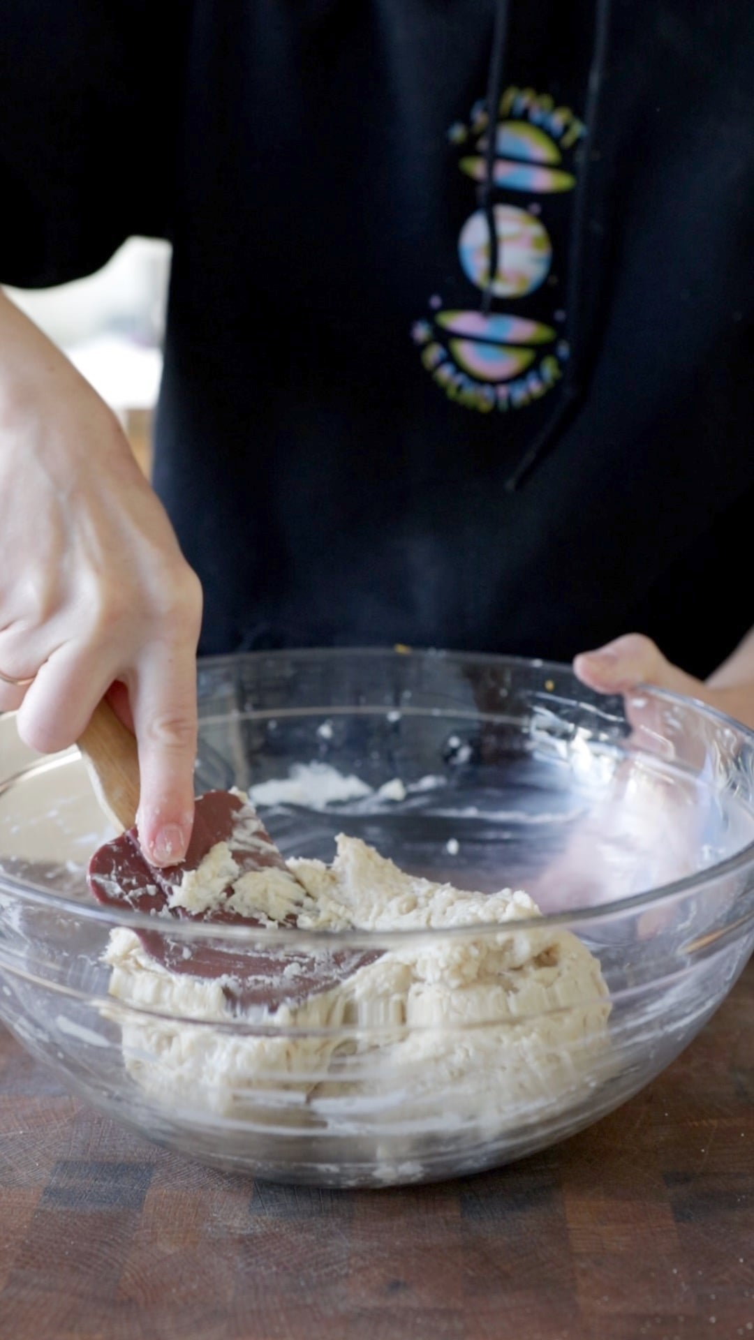 a loose vegan sufganiyot dough being mixed with a rubber spatula