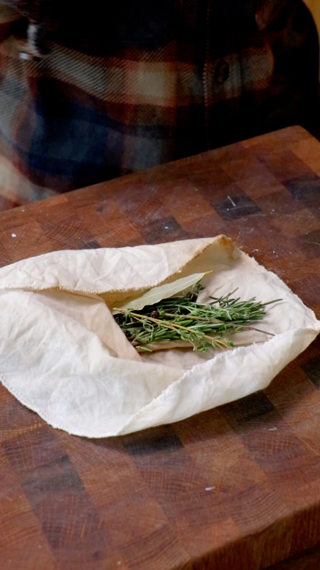 fresh herbs being wrapped in cloth