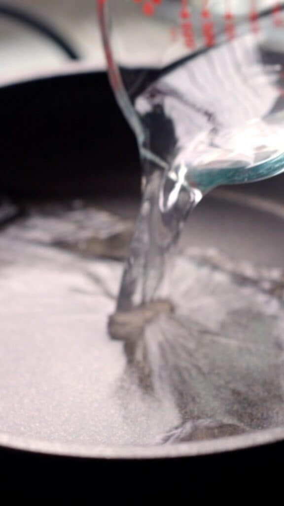 water being poured into a small saucepan