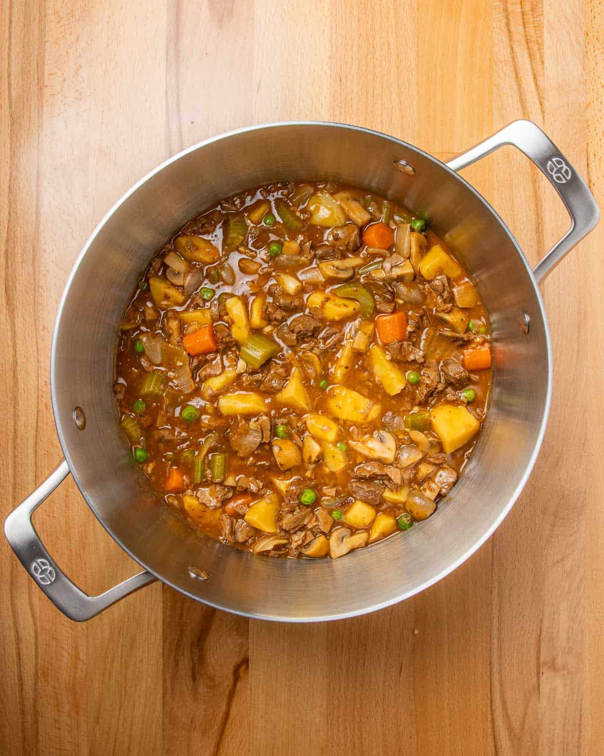 overhead shot of a large stockpot full of vegan beef stew