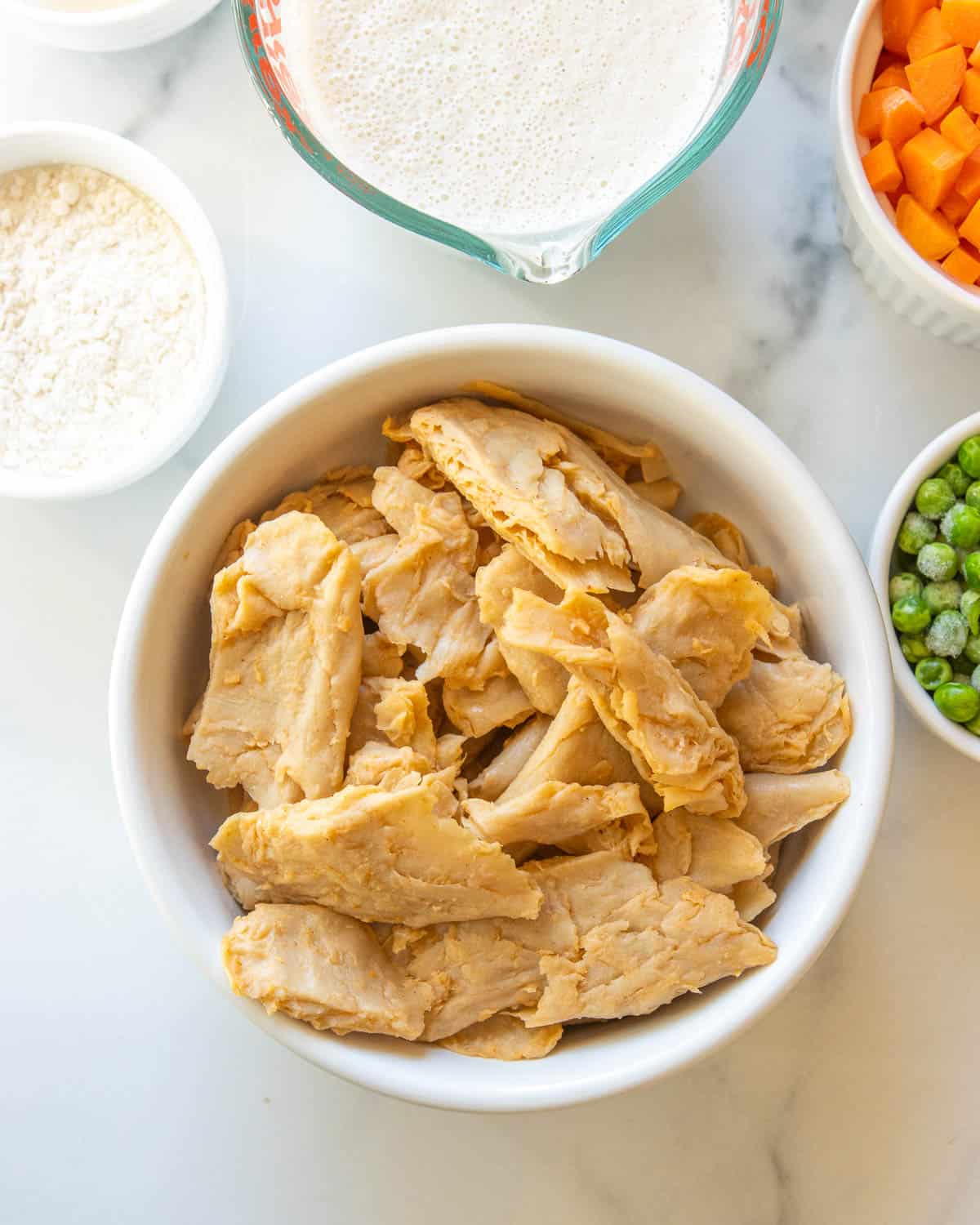 A close-up overhead shot of a bowl of vegan chicken pieces.