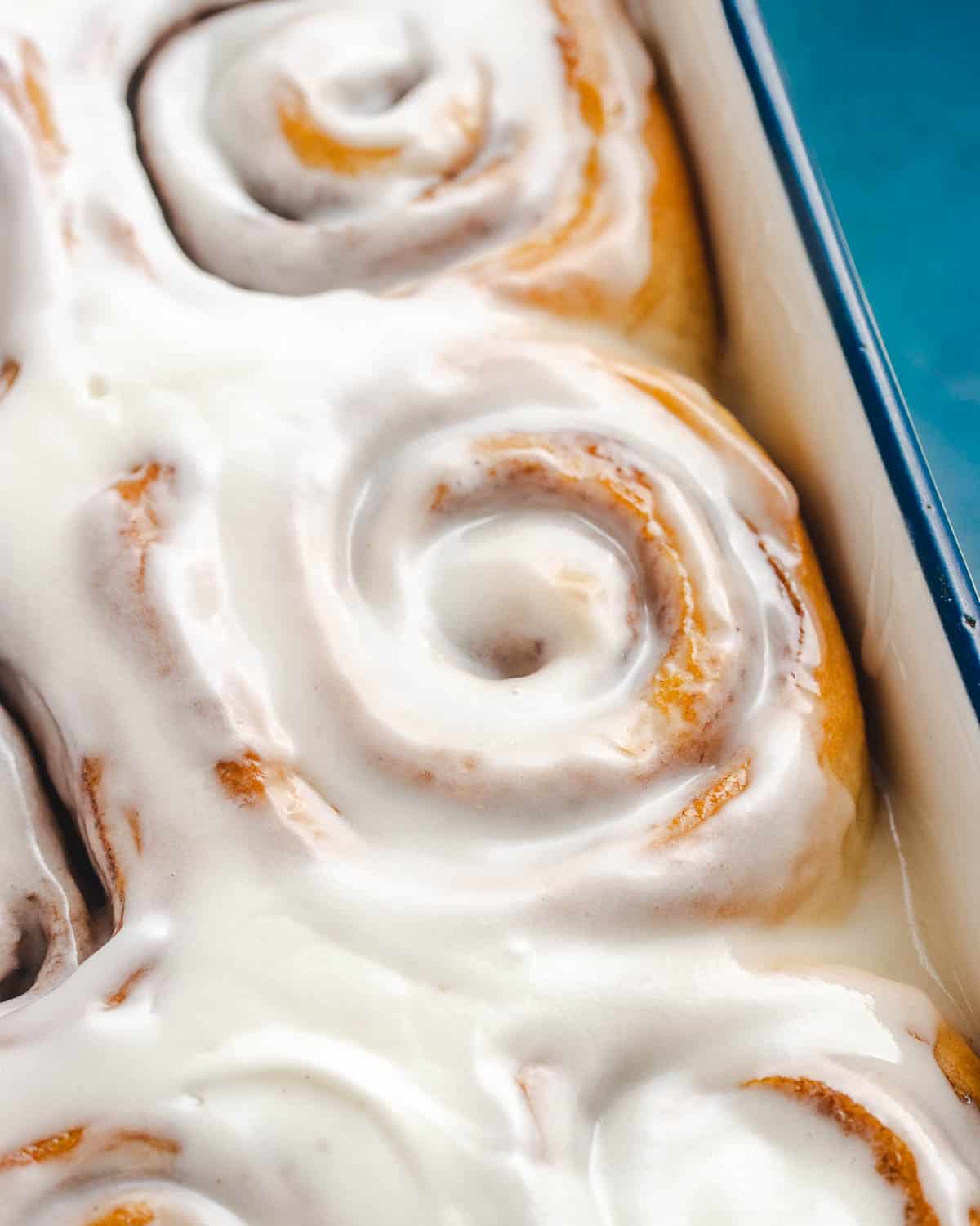 close up of frosted vegan cinnamon bun