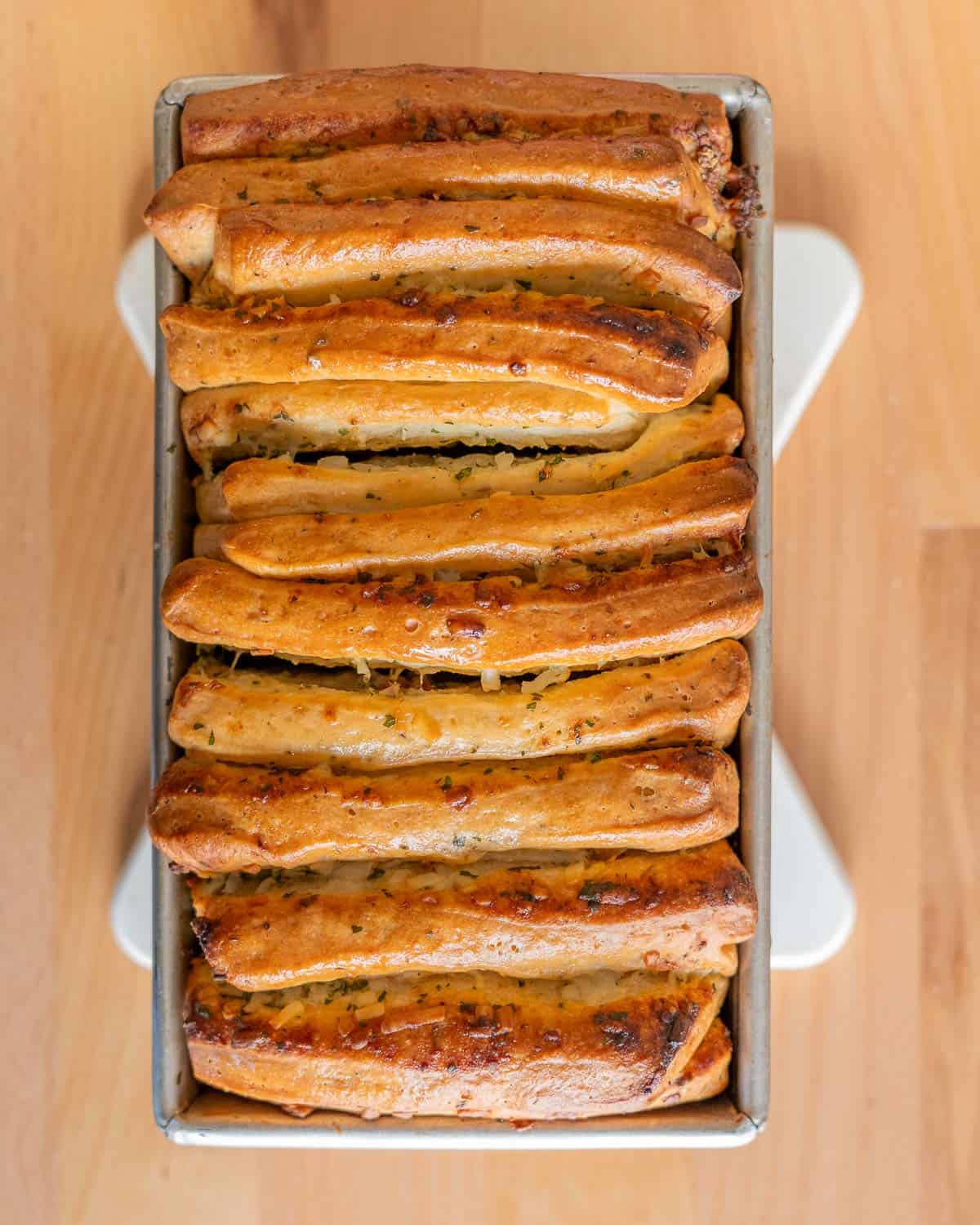 overhead shot of garlic herb pull-apart bread in a tin bread pan