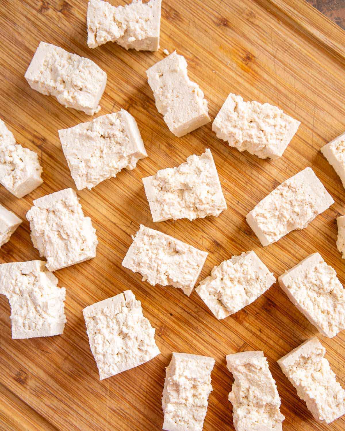 closeup of tofu torn into bite sized pieces