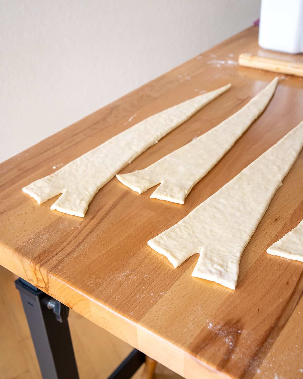 croissant dough cut into long triangles