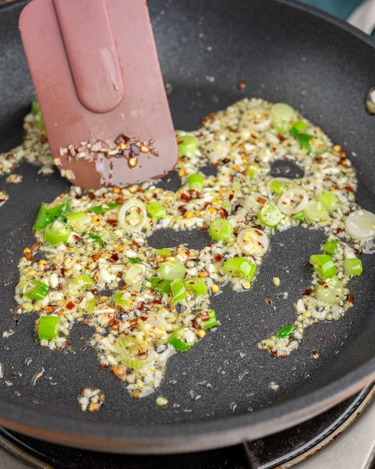 Sautéing aromatics for orange sauce.