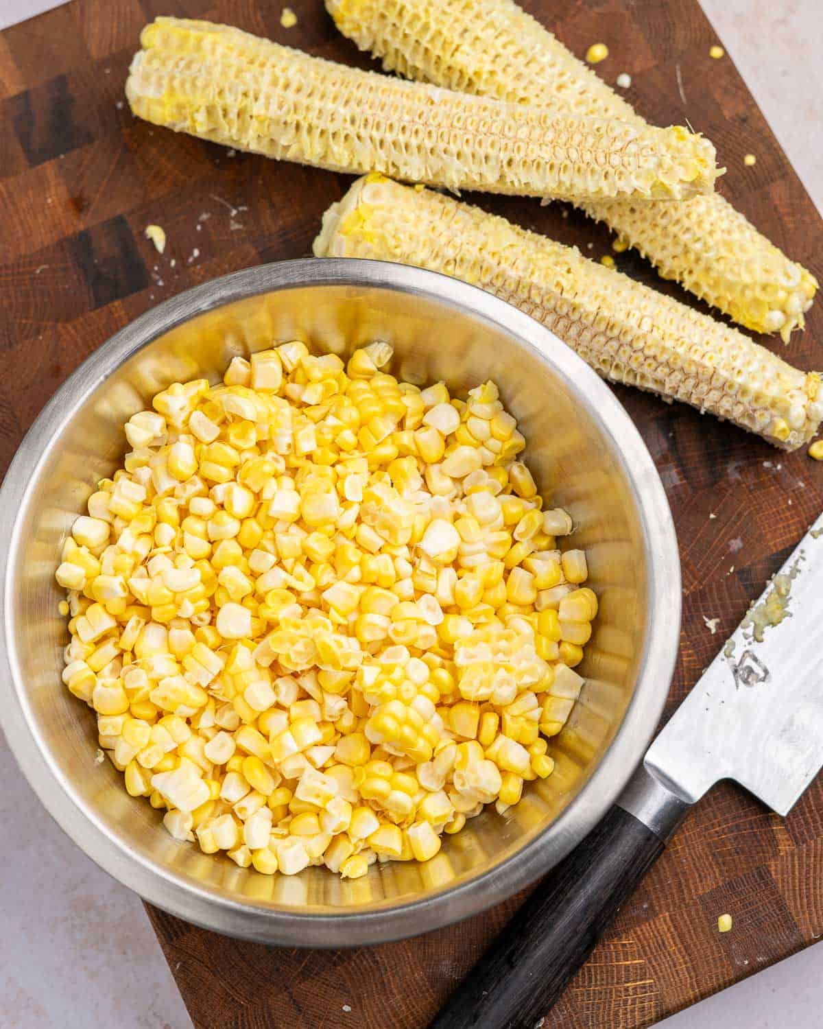 Corn cobs with corn cut off of them and placed in a bowl