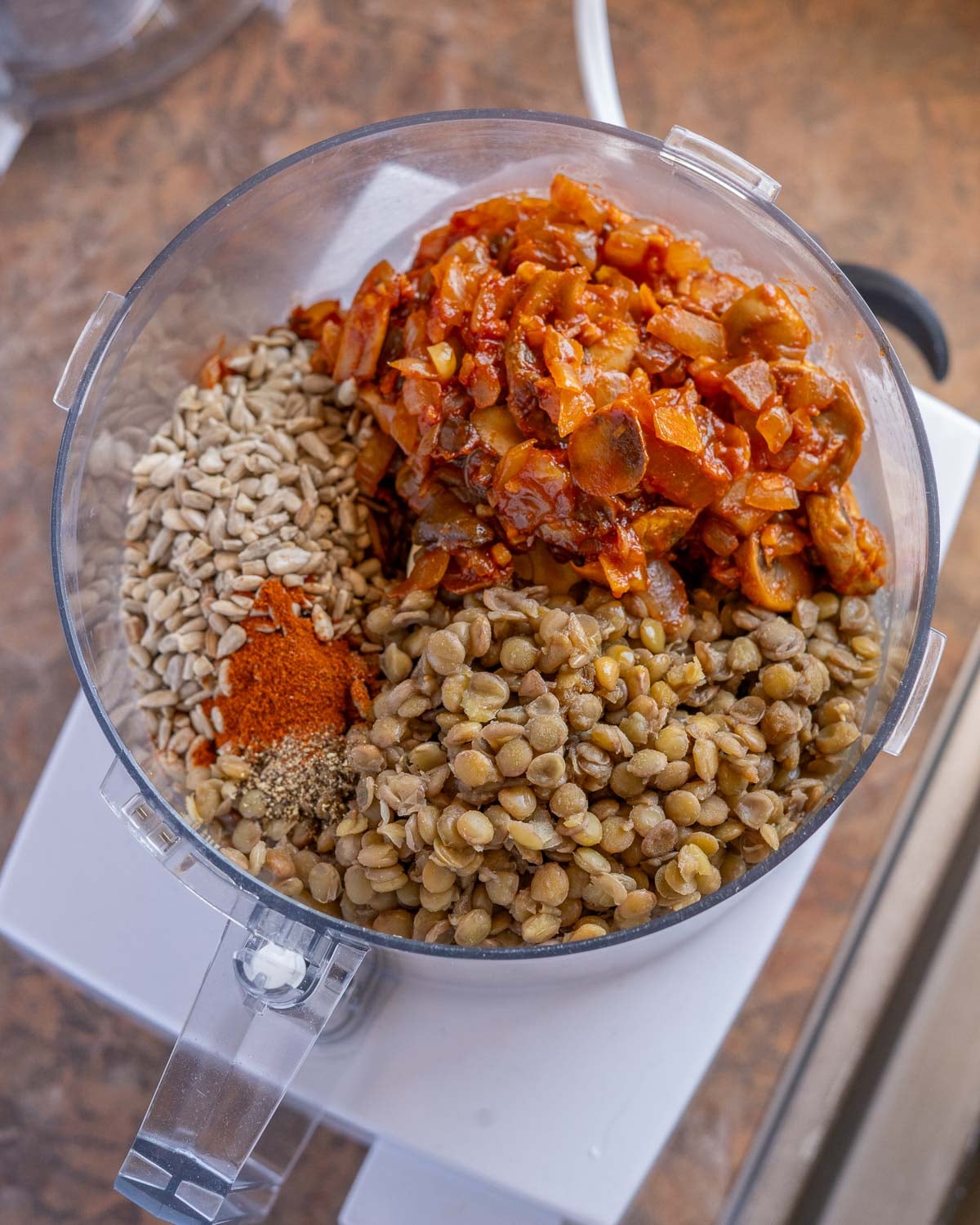 Ingredients fo lentil burgers in a food processor.