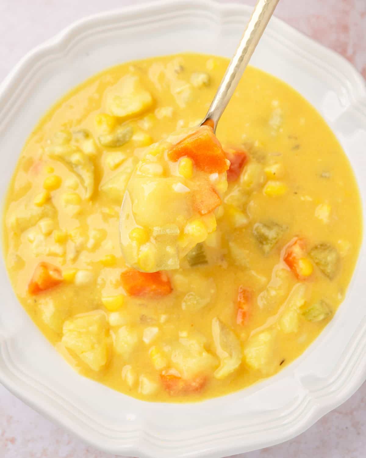 close up of a spoonful of vegan potato corn howder