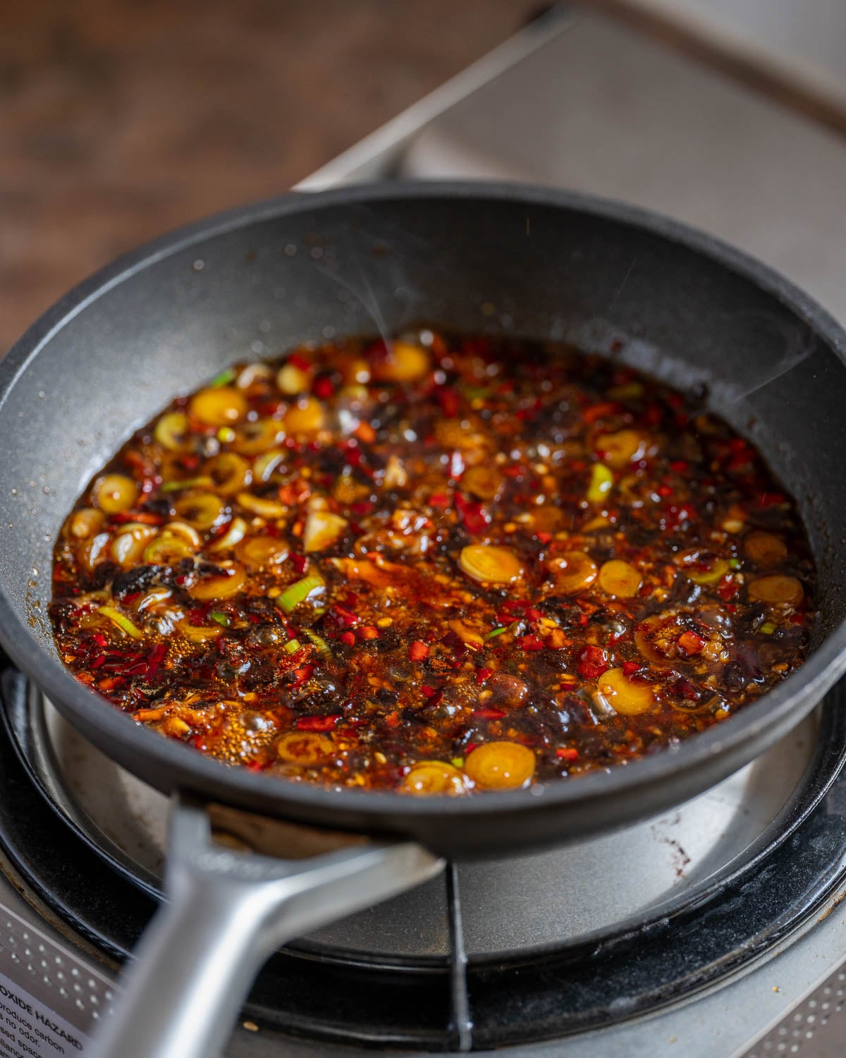 Simmer sauce ingredients to thicken slightly and remove raw garlic flavor