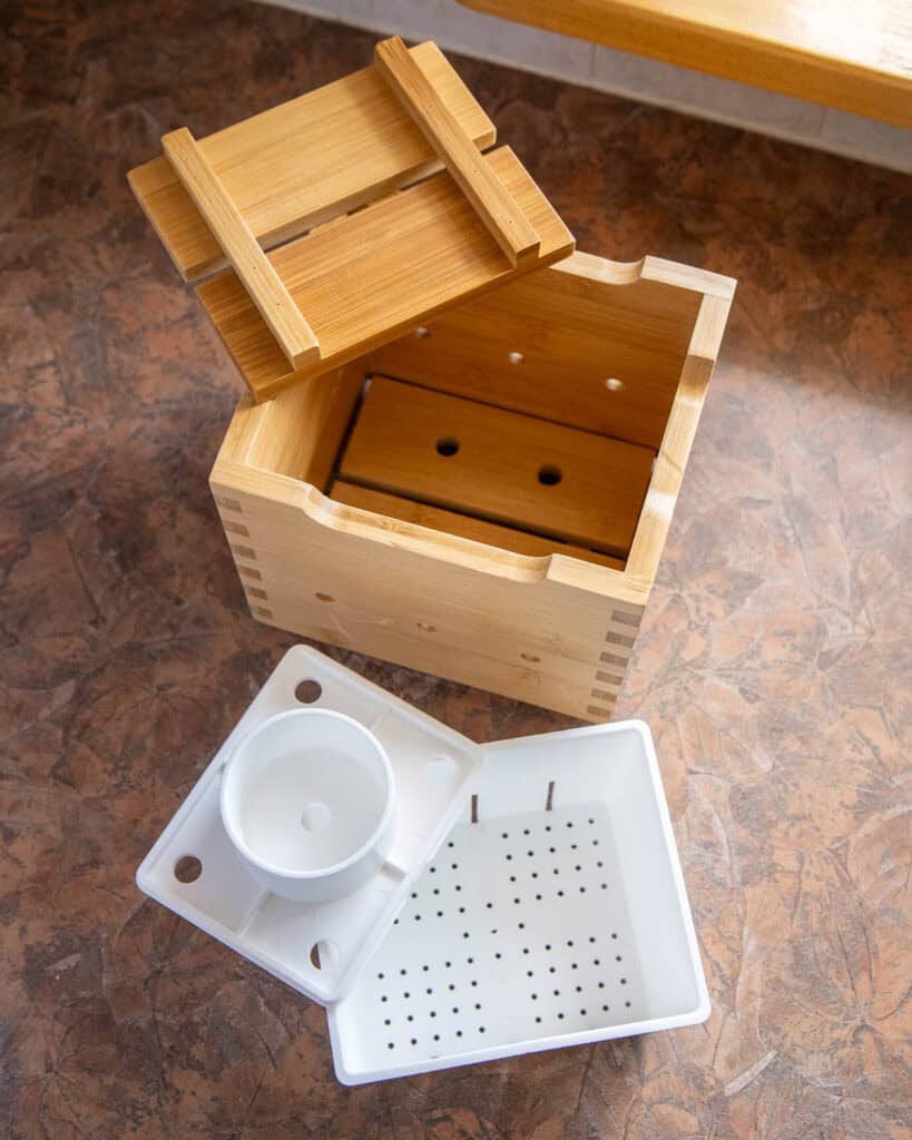Two different options of tofu presses: a plastic one and a more traditional wooden one