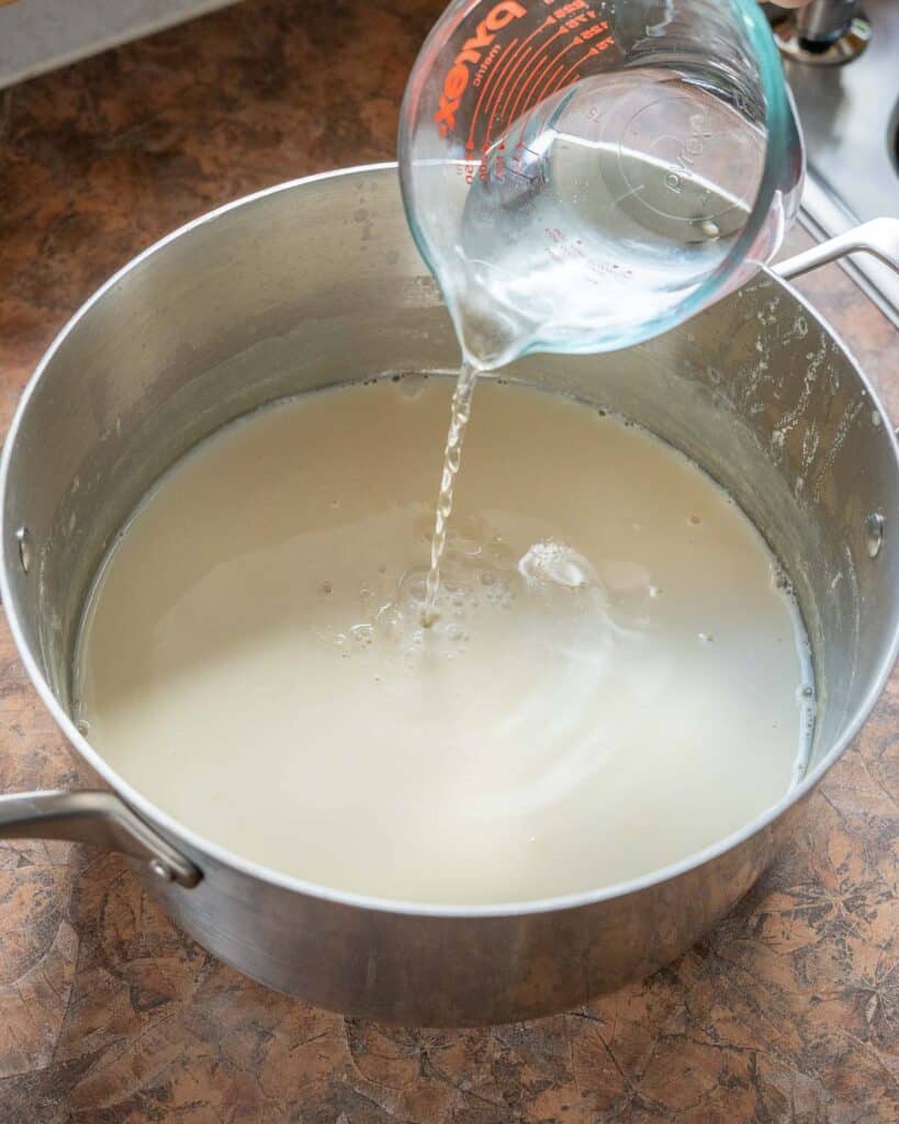 Pouring in nigari mixture to soy milk