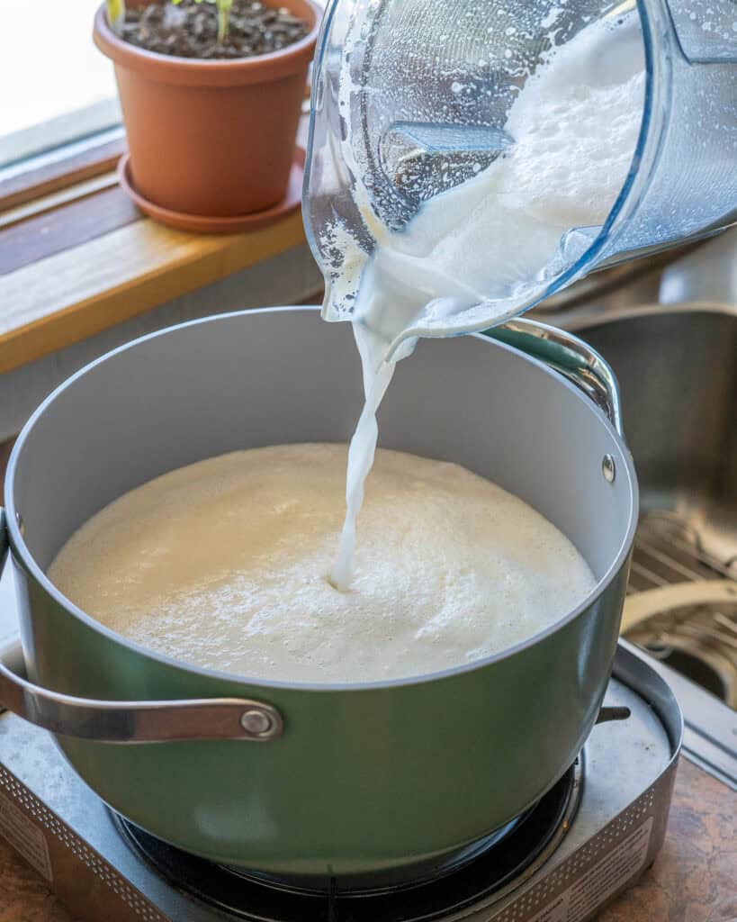 Adding the last of the soy mixture to the pot