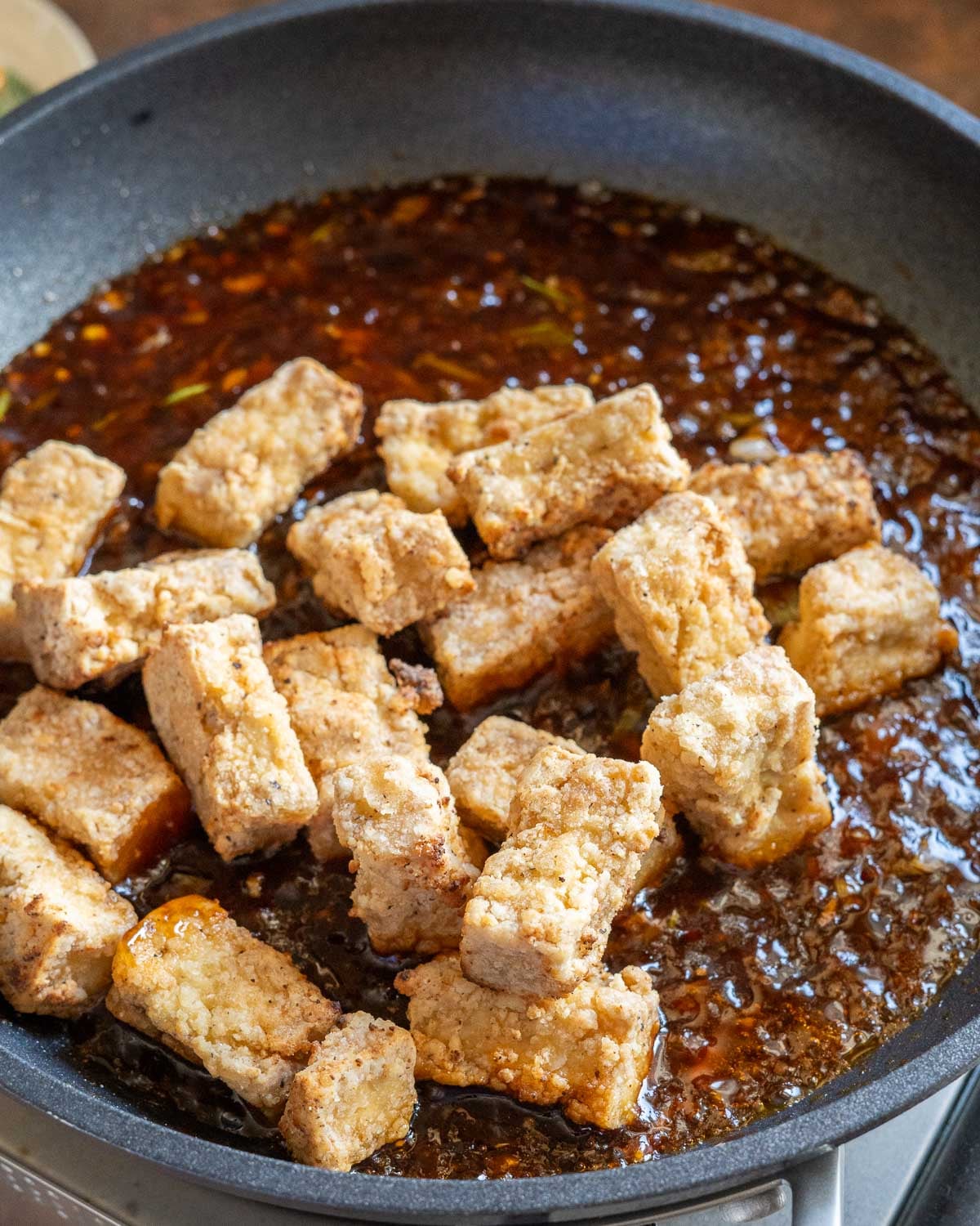 Add crispy tofu and toss in sauce