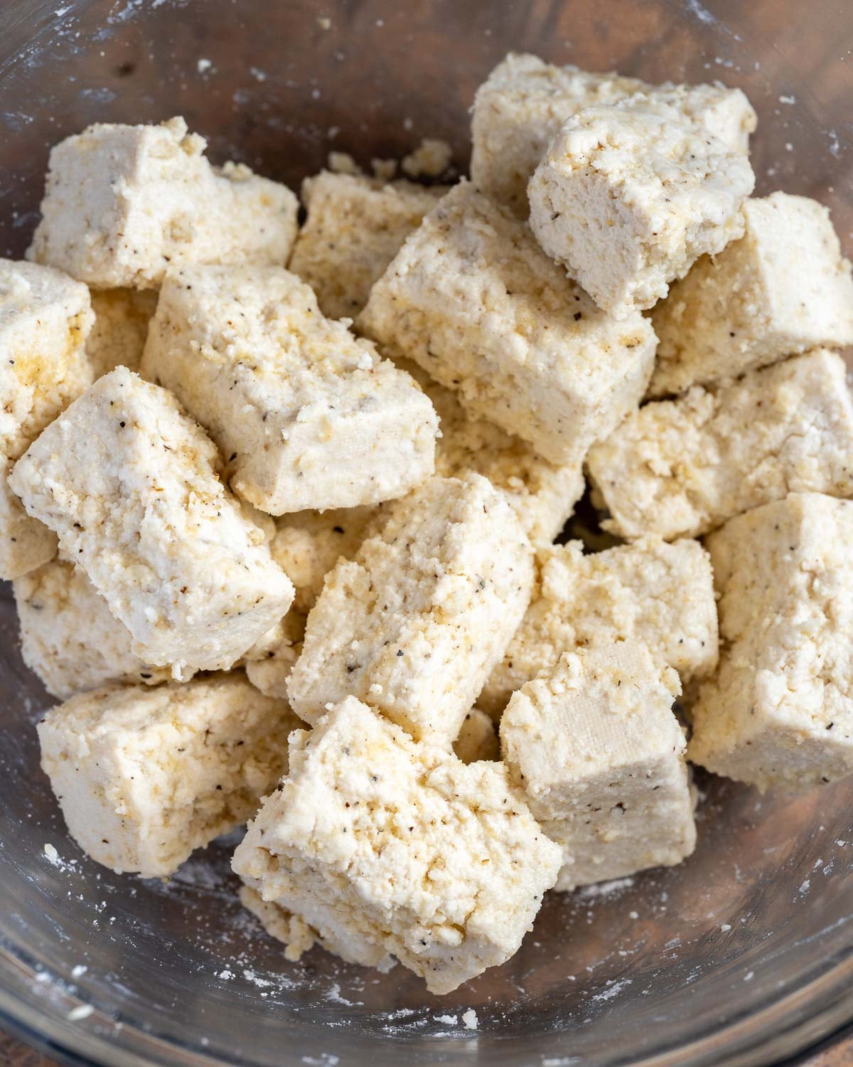 Toss tofu with cornstarch or potato starch