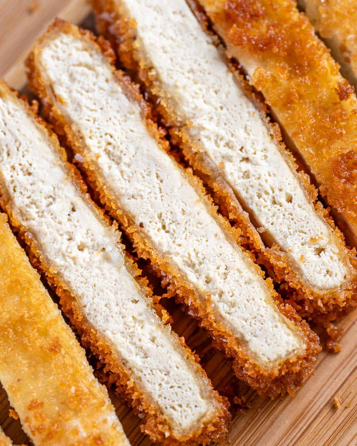 Cross section of tofu katsu to show texture of frozen tofu