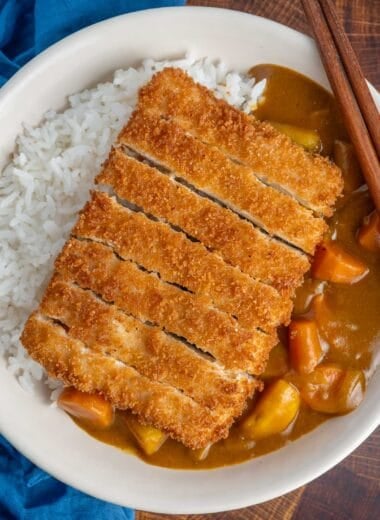 Sliced tofu katsu cutlet on top of Japanese curry and white rice.