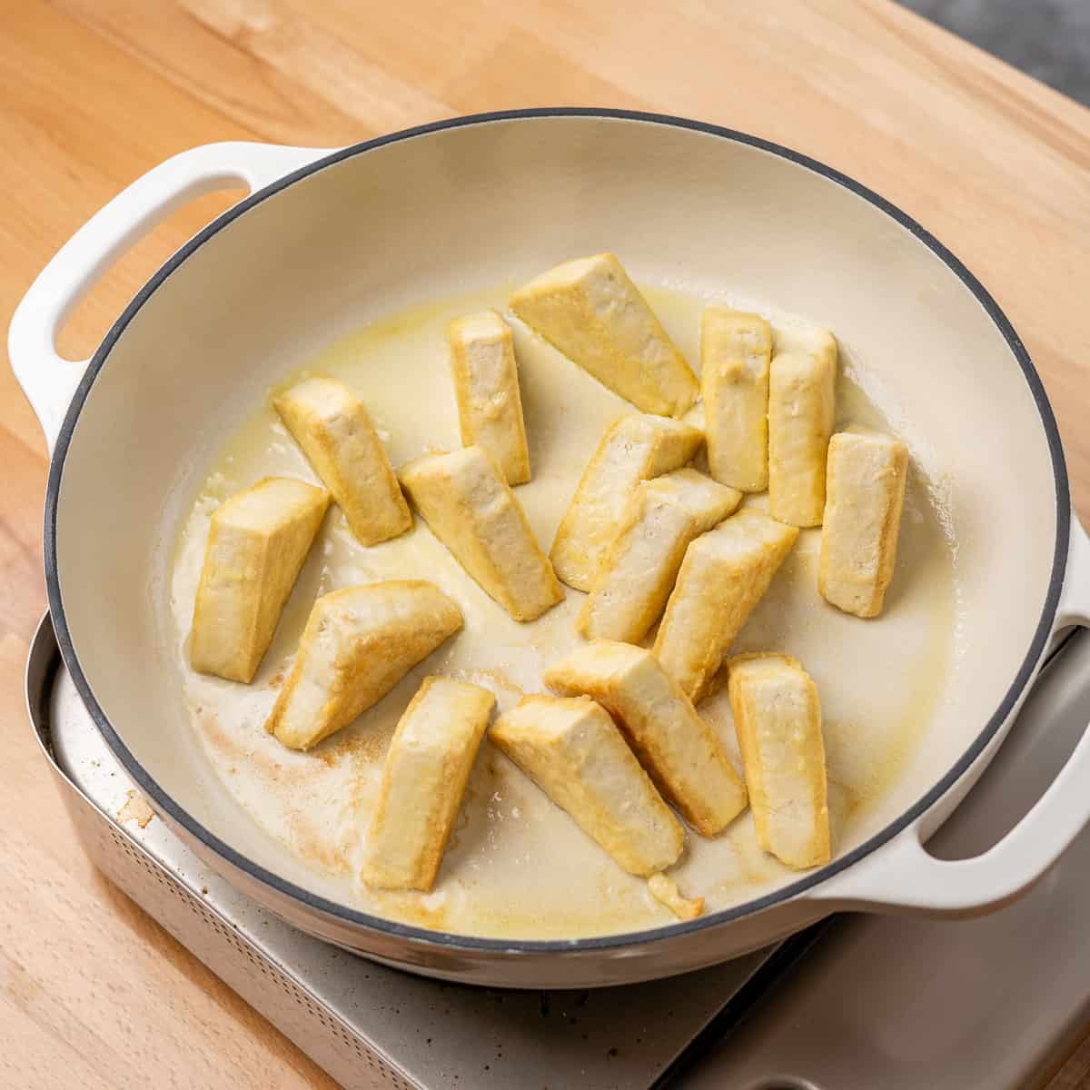 Tofu frying in a pan