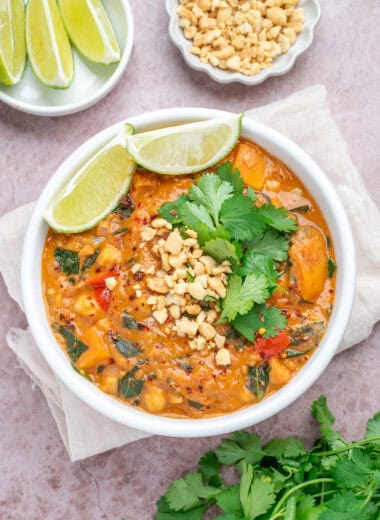 Peanut butter sweet potato stew in a bowl with fresh cilantro and lime