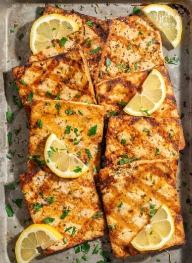 platter of grilled tofu garnished with lemon