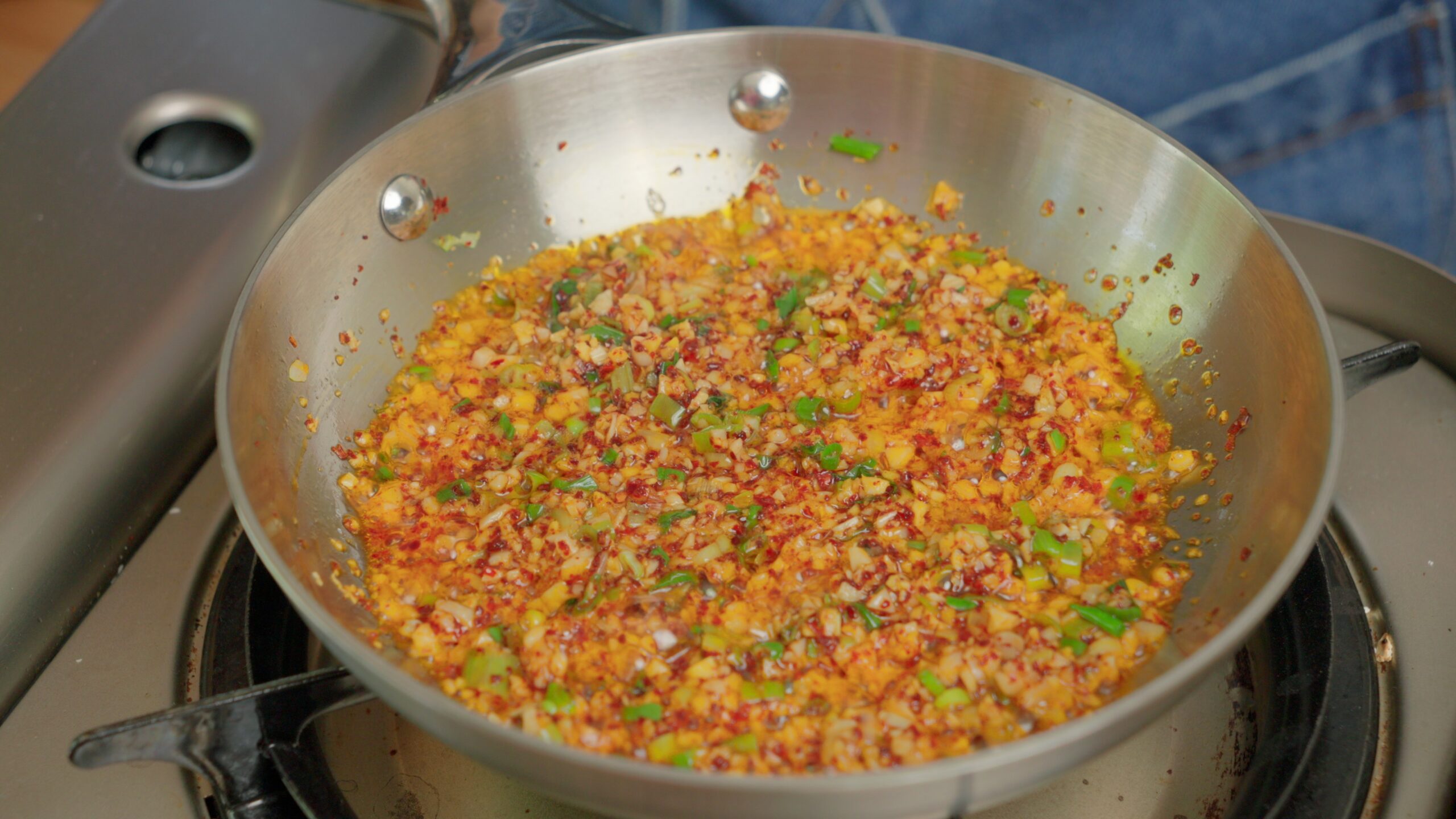 aromatics sizzling in a pan