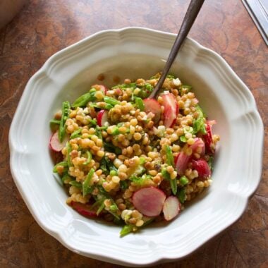 A bowl of spring pearl couscous salad