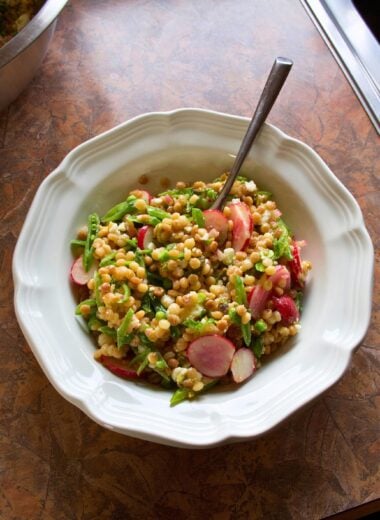 A bowl of spring pearl couscous salad