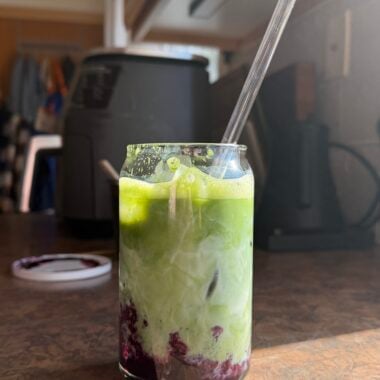 a glass of iced blueberry matcha