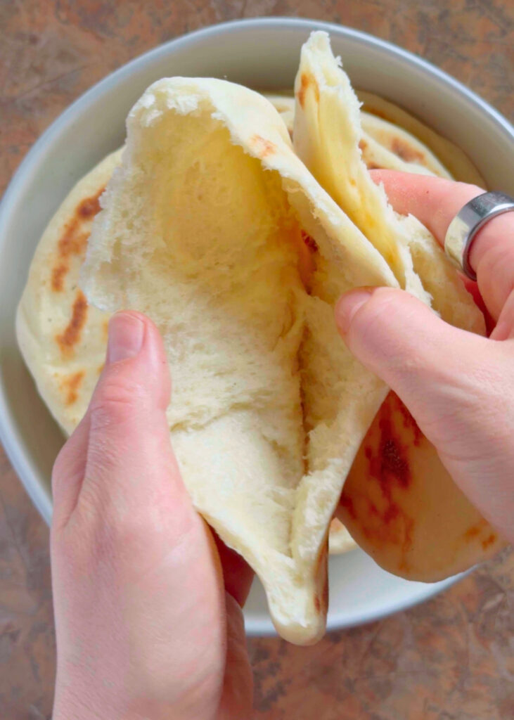 opening a pita to reveal the pocket
