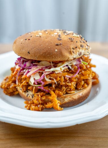 shot of shredded bbq tofu sandwich topped with coleslaw