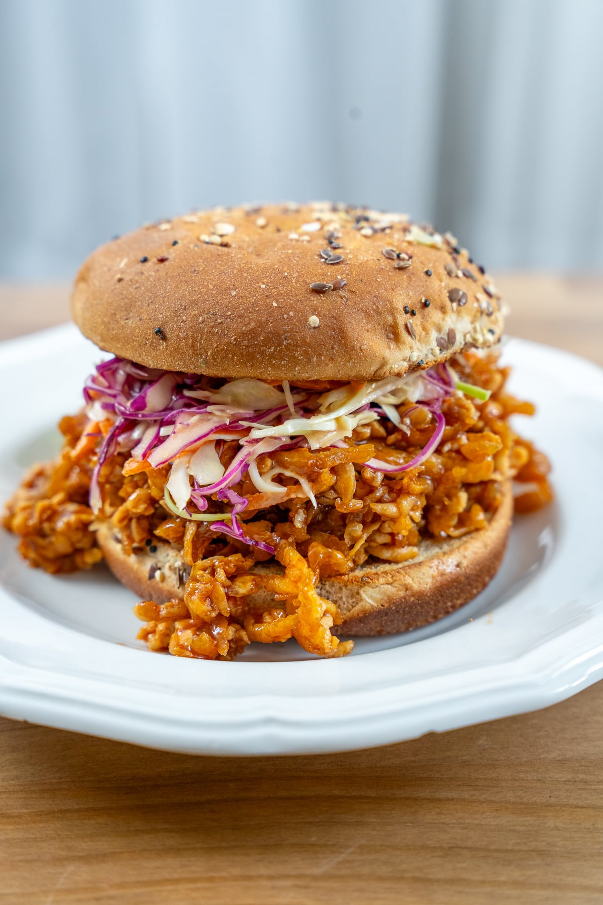 shot of shredded bbq tofu sandwich topped with coleslaw
