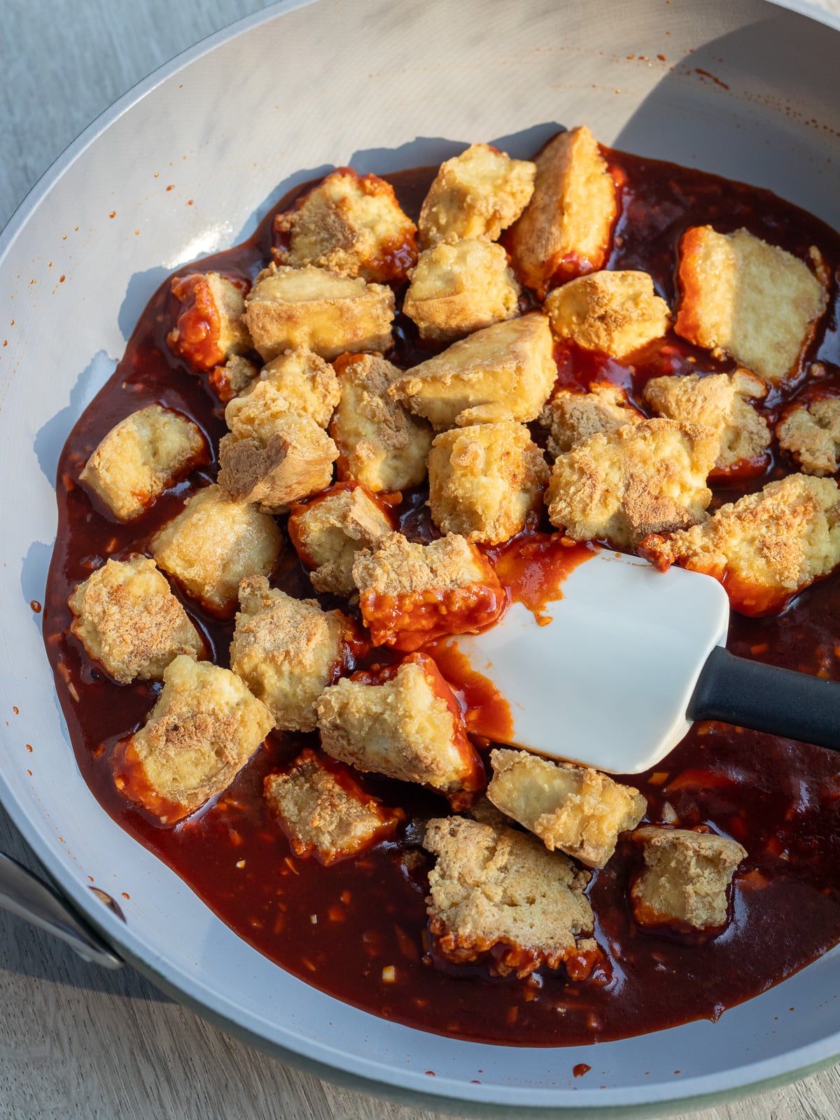 crispy air fried tofu in a pan with gochujang sauce