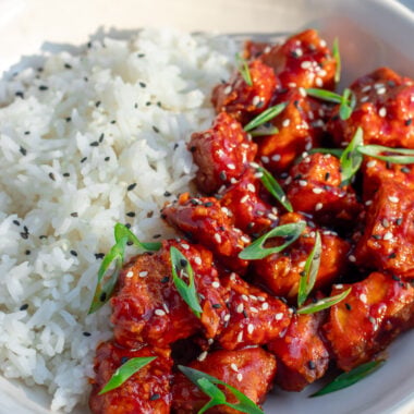 saucy gochujang tofu with steamed rice in a bowl