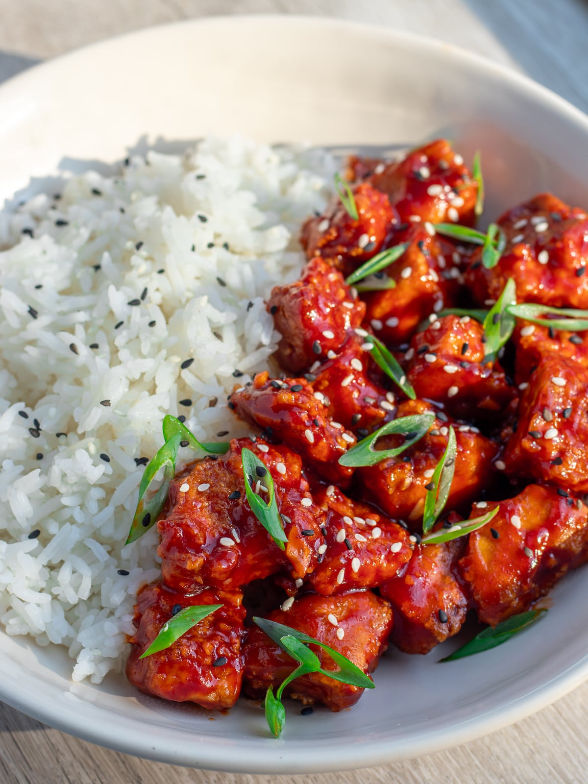 saucy gochujang tofu with steamed rice in a bowl